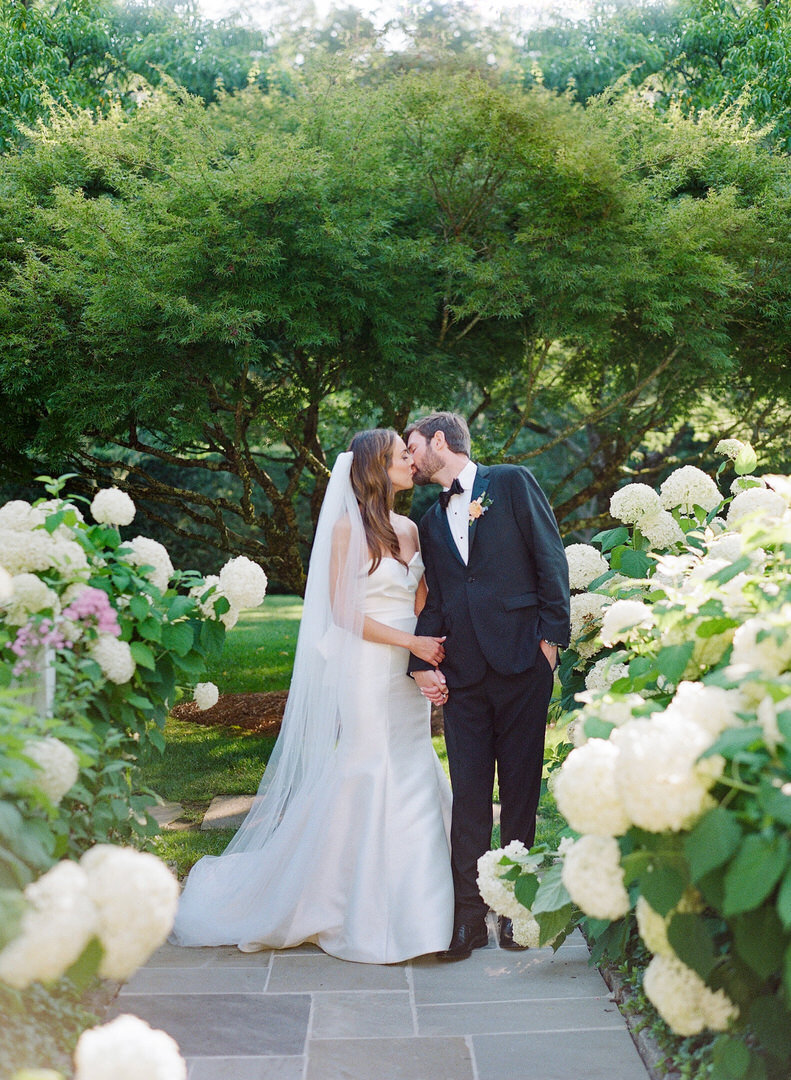 Bride and Groom Kissing at Alter Photo