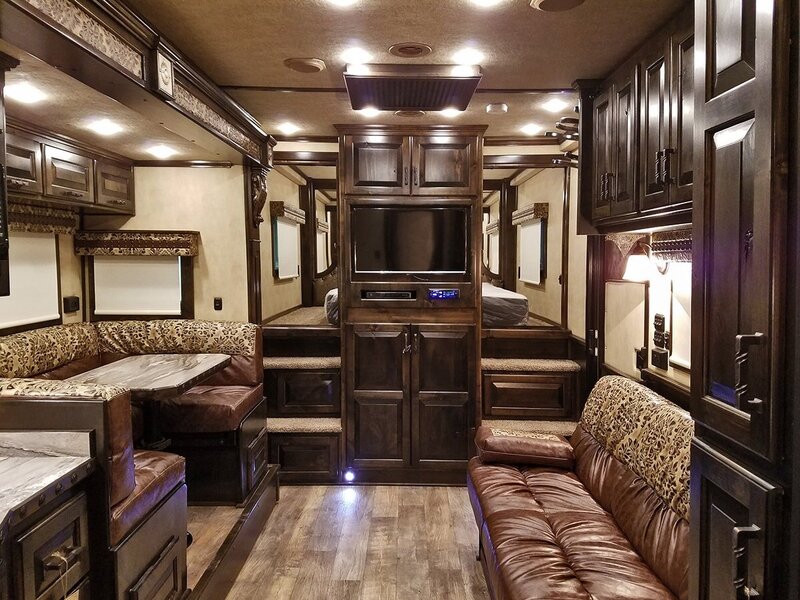 Dark cabinets surrounding a living room in a customized luxury horse trailer
