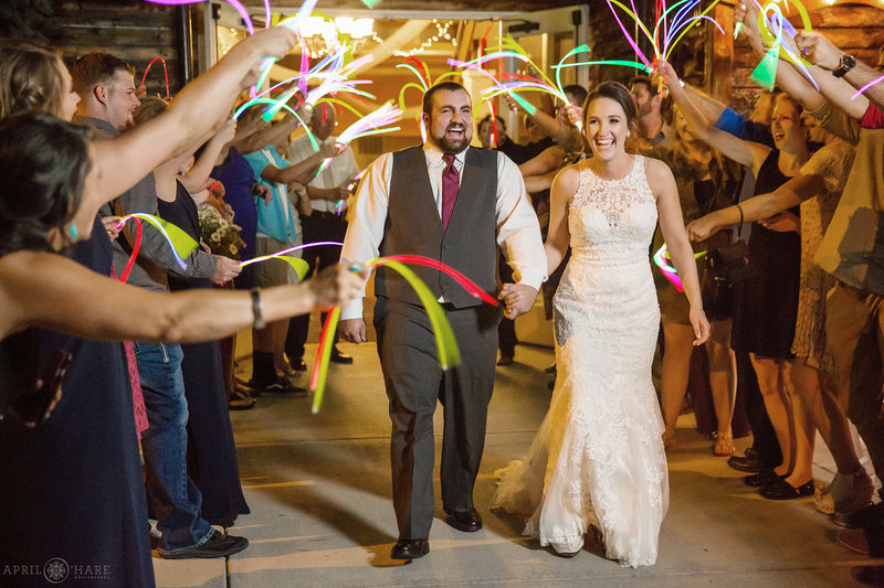 Couple exits their wedding reception with glow sticks at Church Ranch Event Center