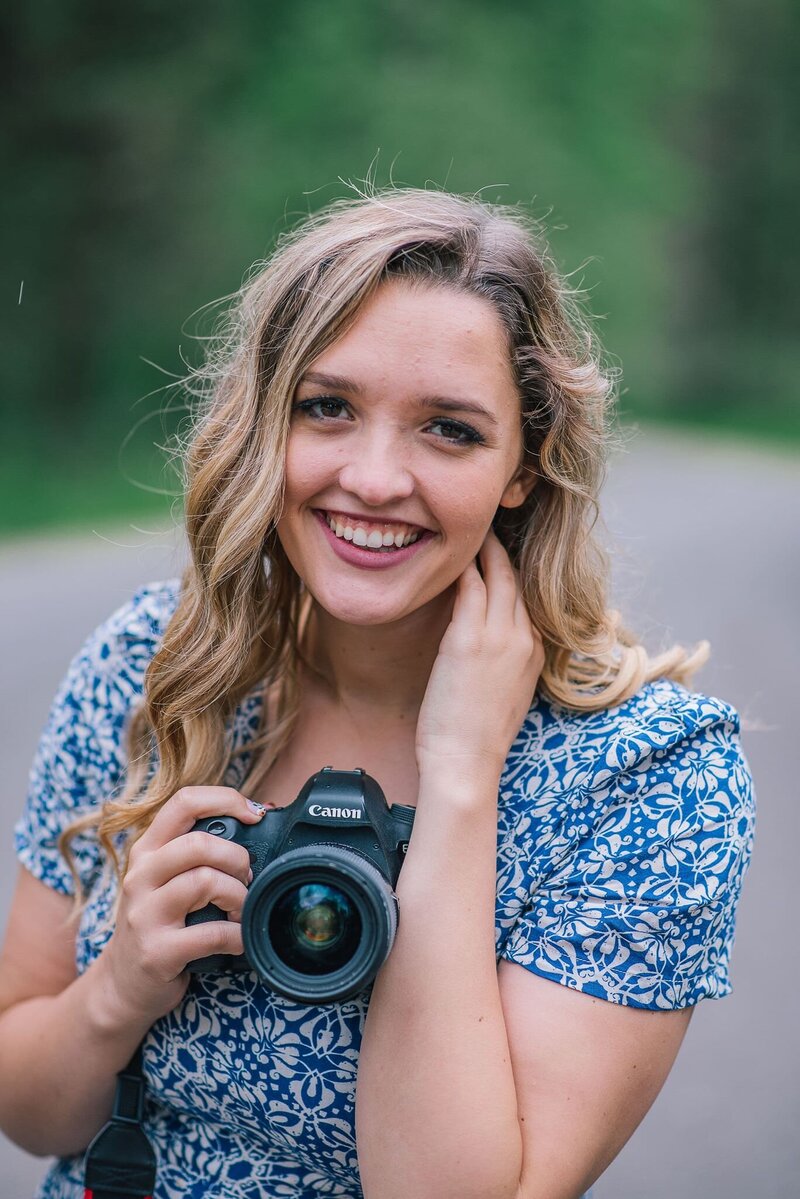 Sacramento Wedding Photographers capture woman holding camera and smiling