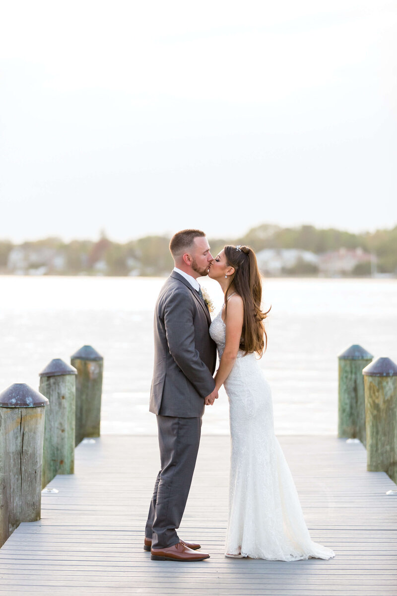 Clarks wedding bride and groom kissing on dock