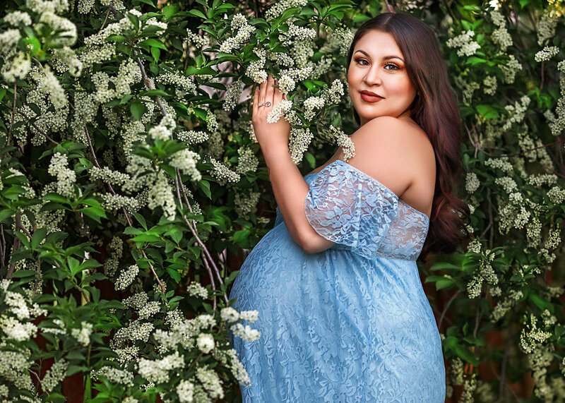 Momma to be posing in beautiful  light blue dress at her denver maternity  photgraphy session
