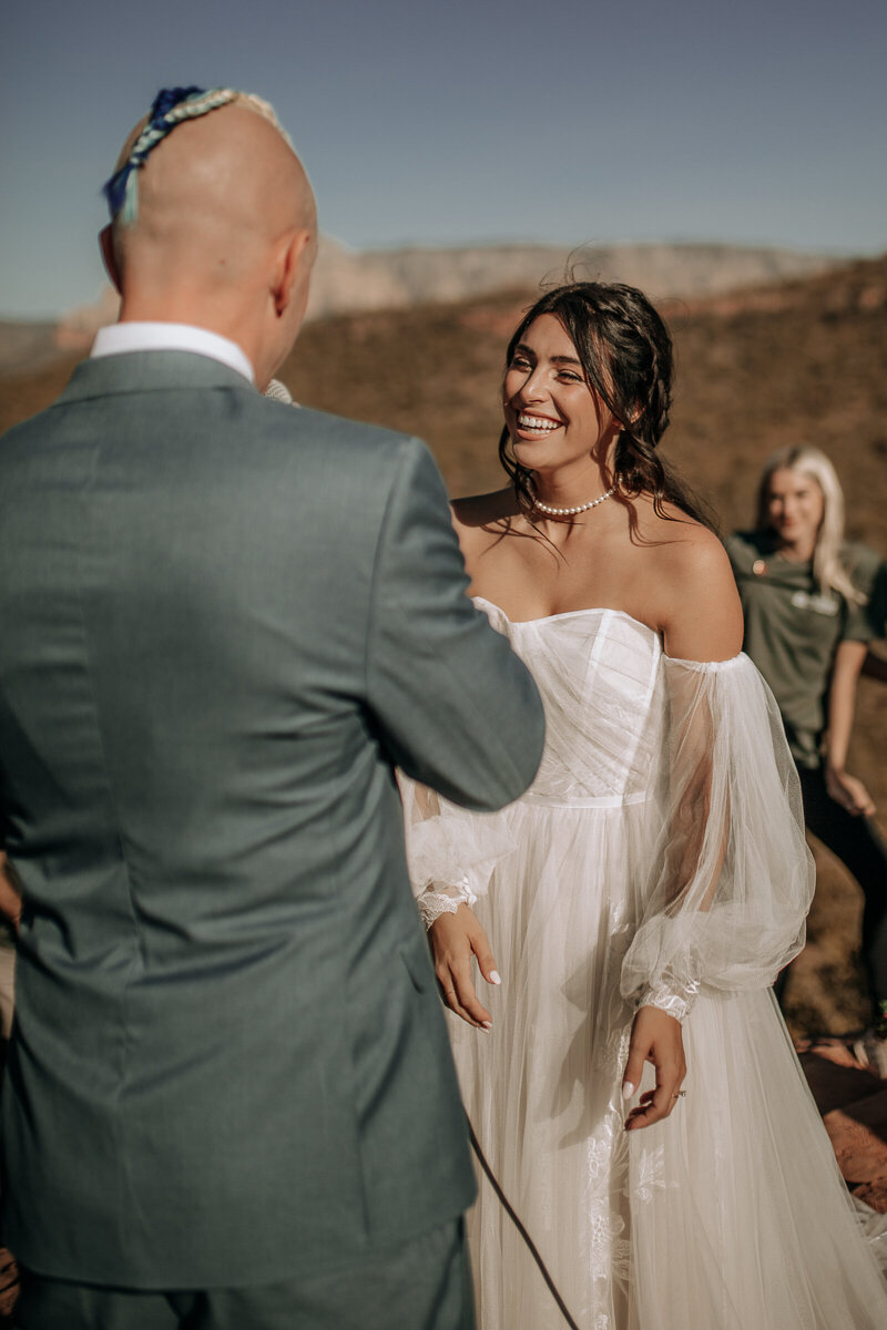 bride laughing at grooms wedding vows in sedona