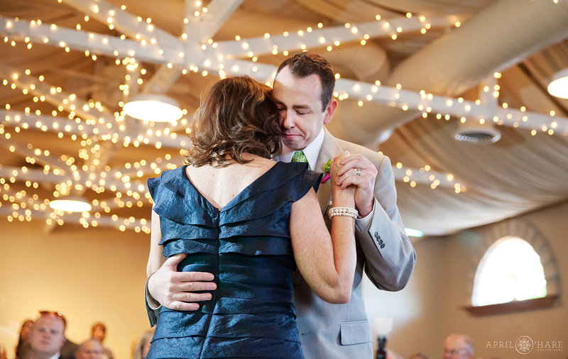 Groom dances with his mom under the rafters at the Reception pavilion at Tapestry House in Fort Collins