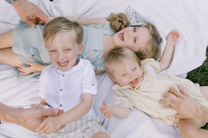 Pile of kids laughing during family portraits