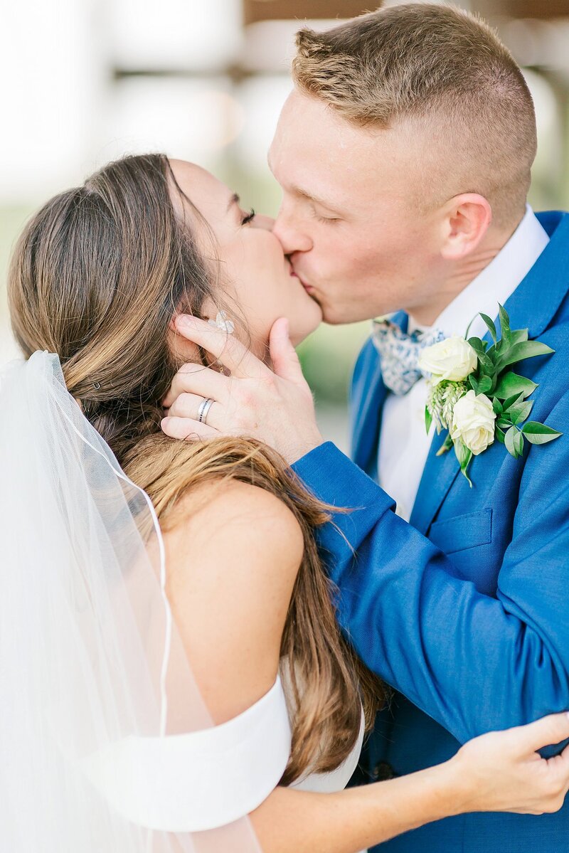 Bride and Groom share a kiss at New Water Farms Wedding Lake Martin by Wedding Photographer Amanda Horne