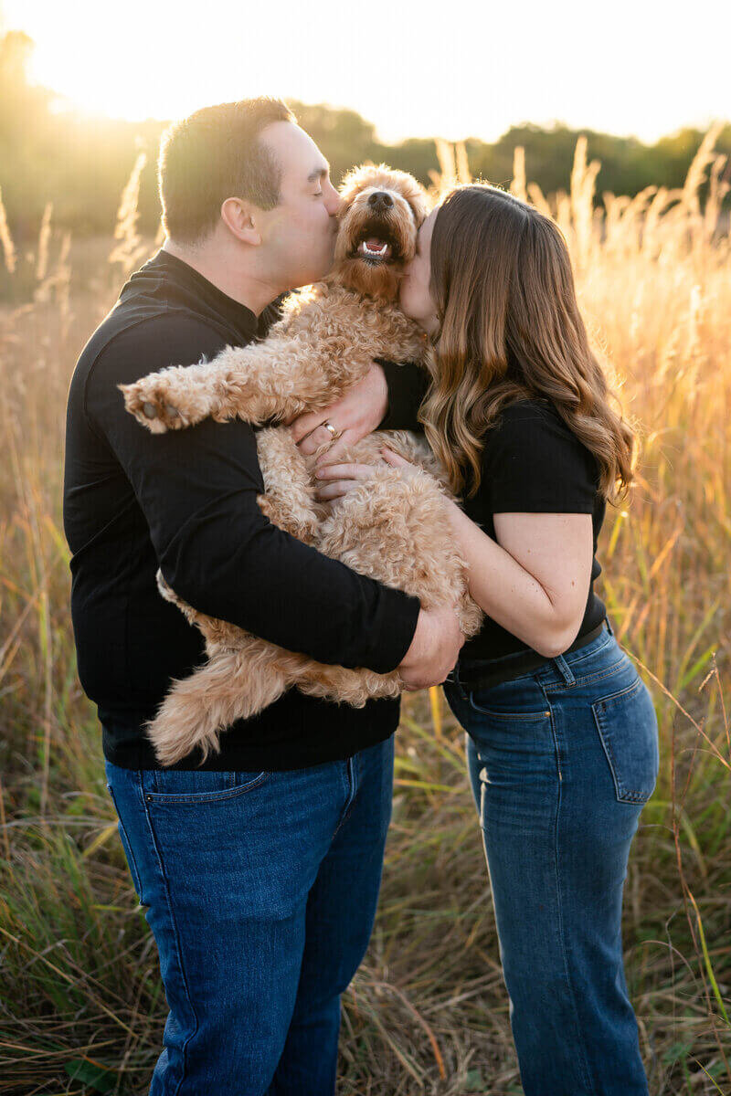 couple kissing dog taken by engagement photographer atlanta