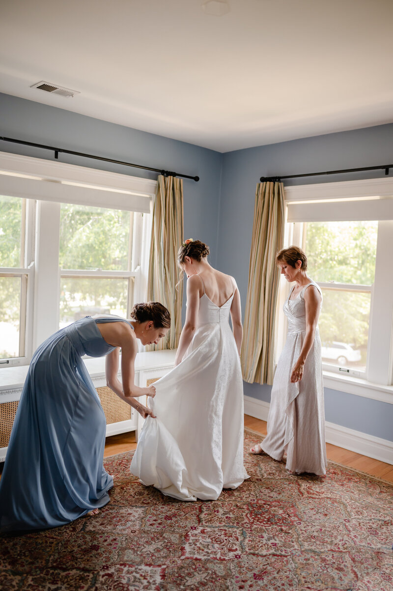 Bride puts on her wedding dress in a vintage house
