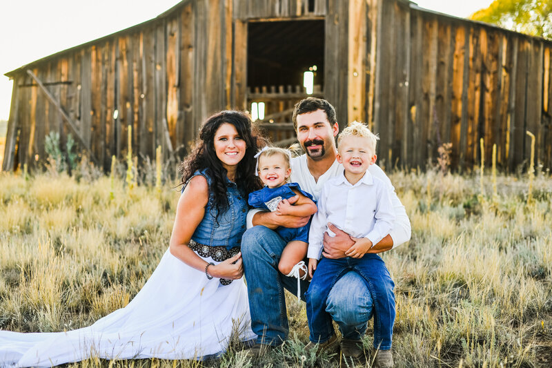 Flagstaff family smiling at camera country barn abandoned
