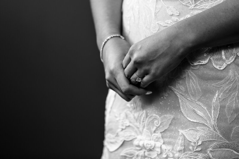 Close up photo showing bride's hands with focus on her rings