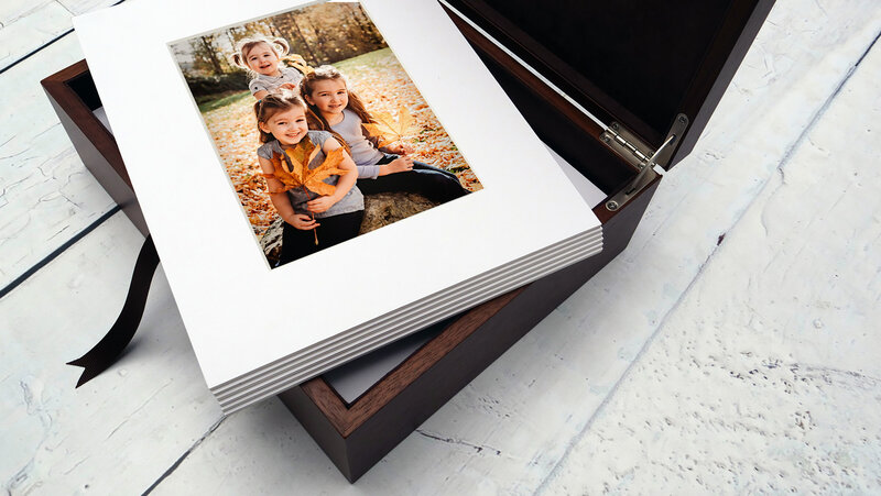 Box filled with matted printed photographs