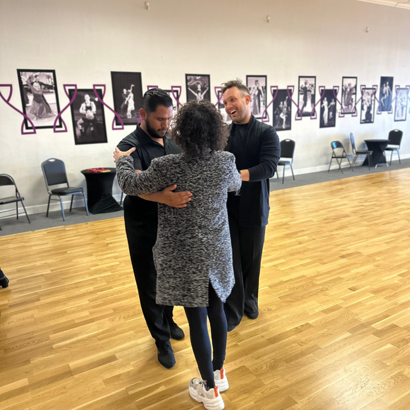 A dedicated instructor provides one-on-one coaching during a private ballroom dance lesson at AZ Ballroom Champions, ensuring personalized attention and tailored guidance for every student.