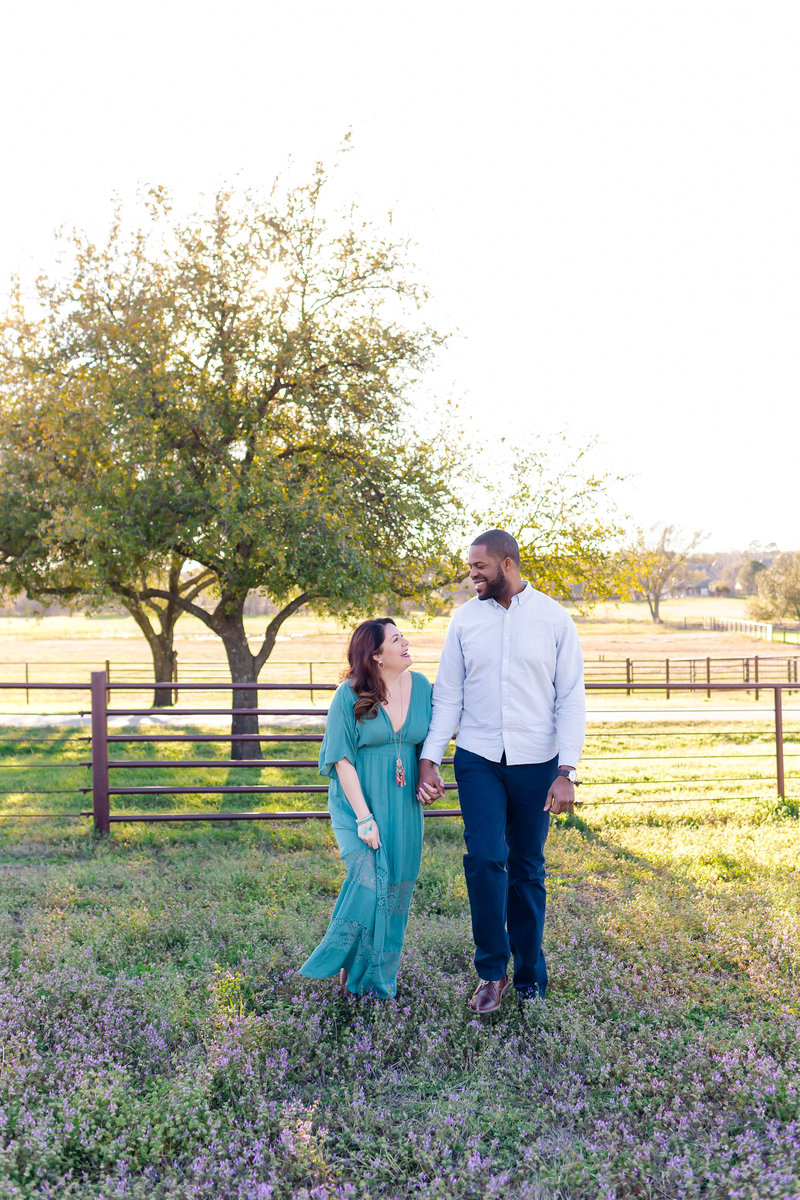 Jill of Jill Blue Photography and her husband in a field of wildflowers