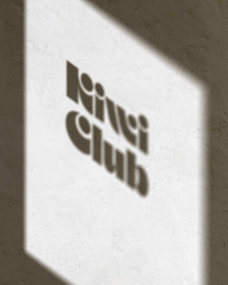 Shadow of Kiwi Club logo on a window