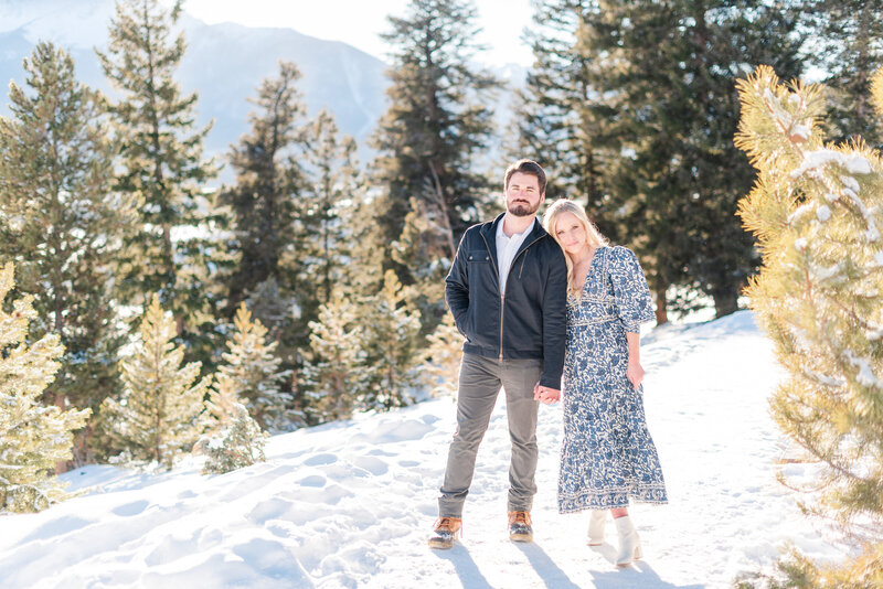 Couple standing side by side in the snow at Sapphire Point at Lake Dillon.