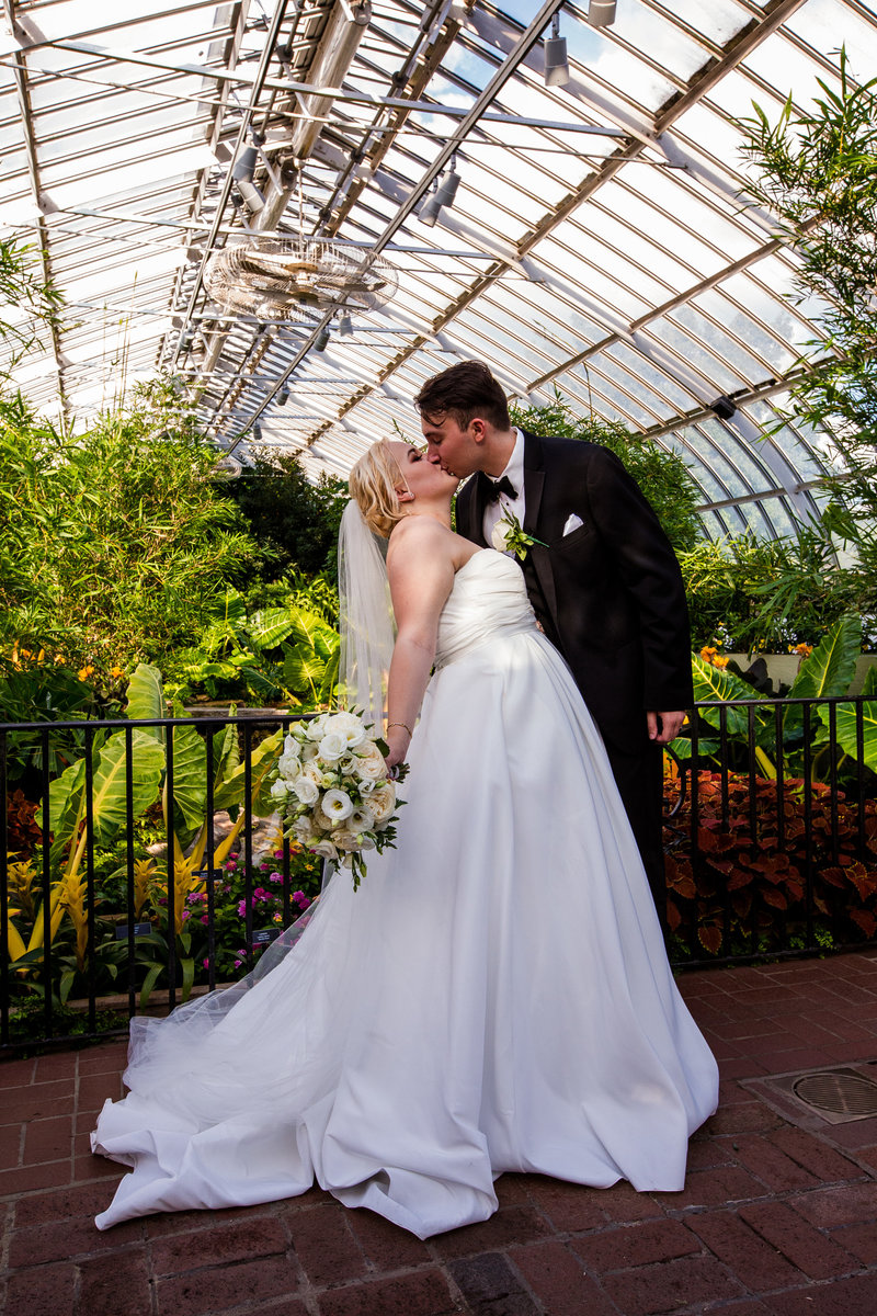 Bride and groom kiss at Phipps Conservatory wedding