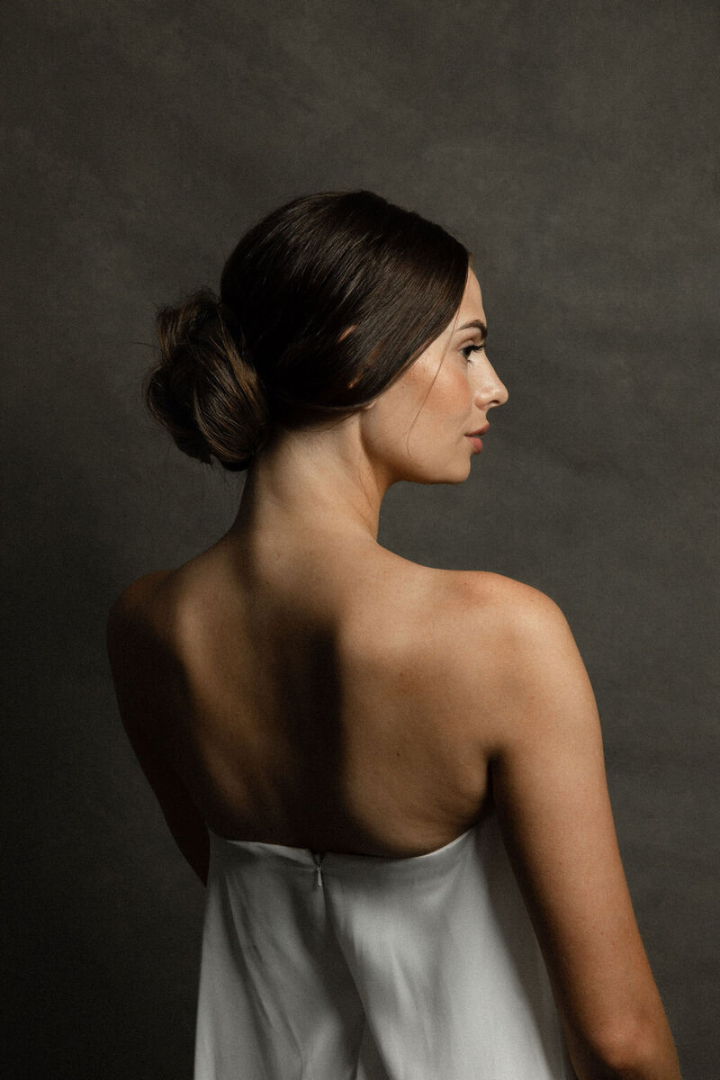 Side profile of a brunette bridal updo hairstyle