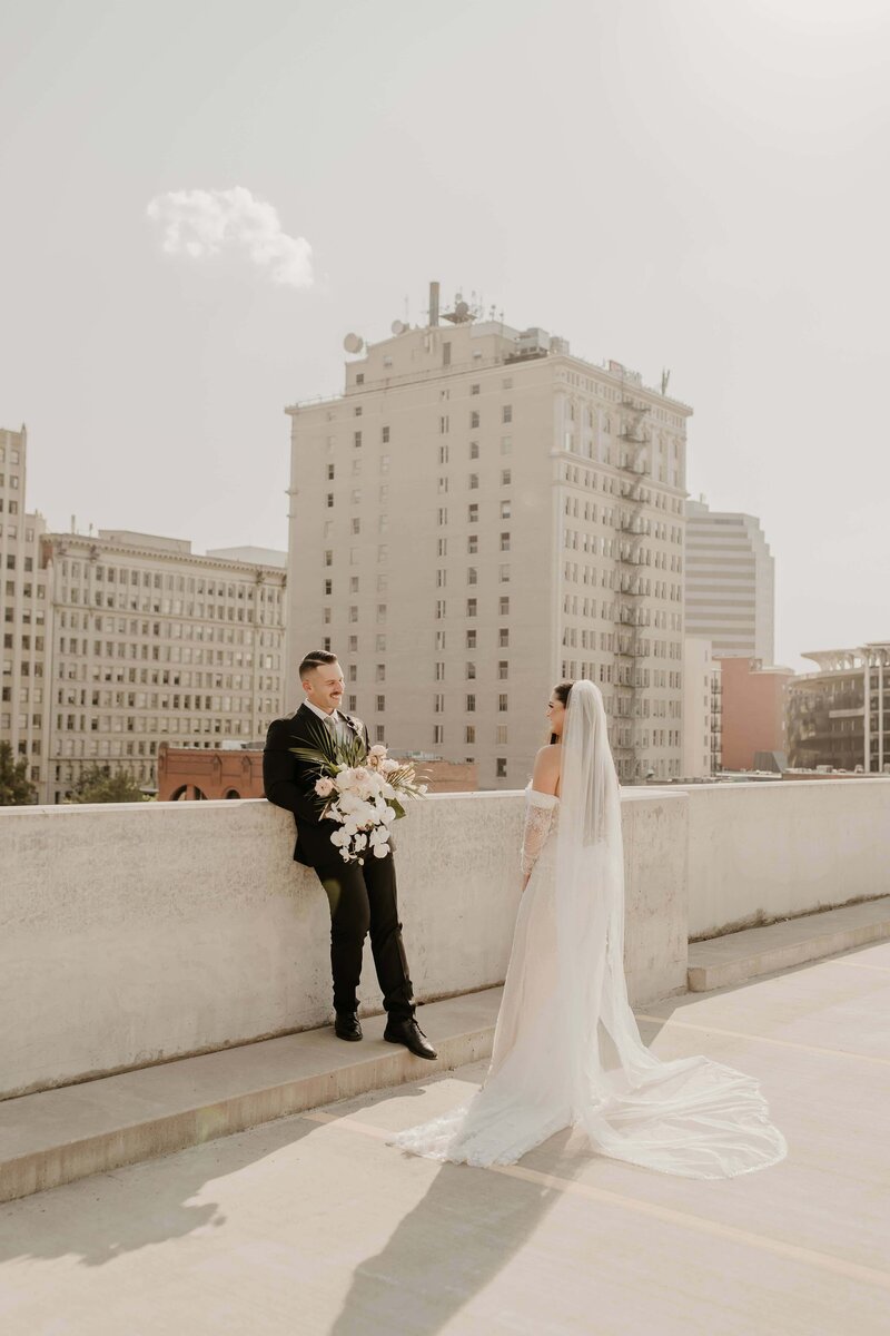 Couple Posing on a Rooftop with the Skyline in the Background - Darby & Garrett | Timbers on Pacific Wedding Spokane Washington