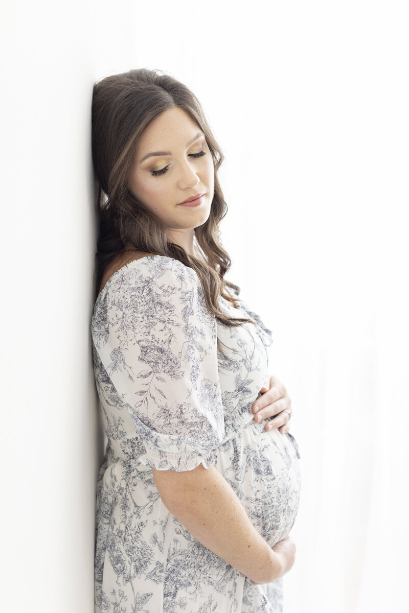 Pregnant mom in floral dress  by Philadelphia Maternity Photographer