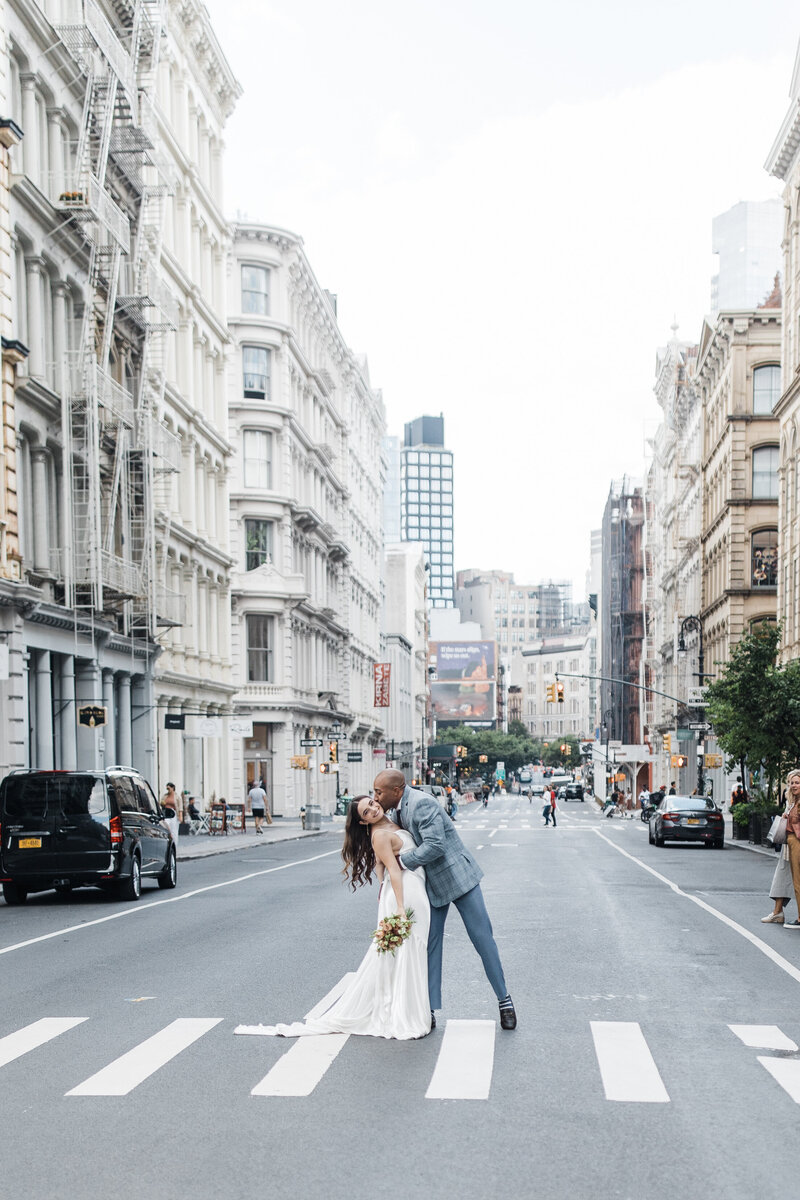 Groom kisses bride in the middle of the street in NYC