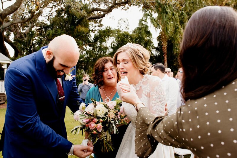 Bride gets emotional while holding groom's hand as she gets to the altar
