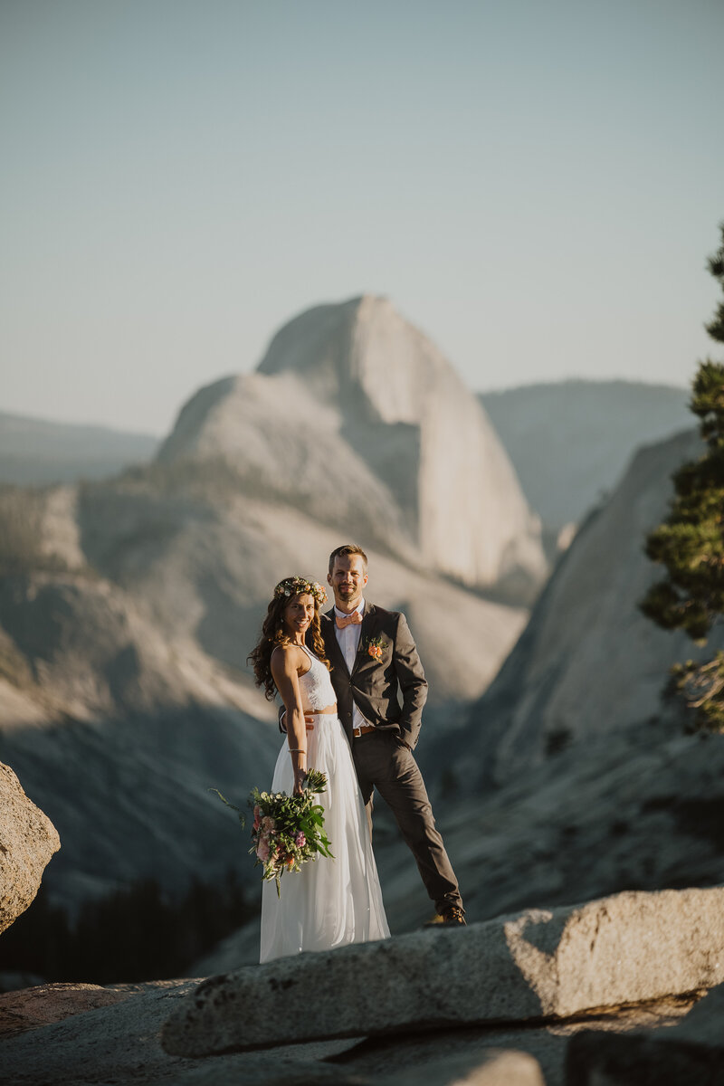 Bride and Groom with Half Dome in the background while in Yosemite National Park