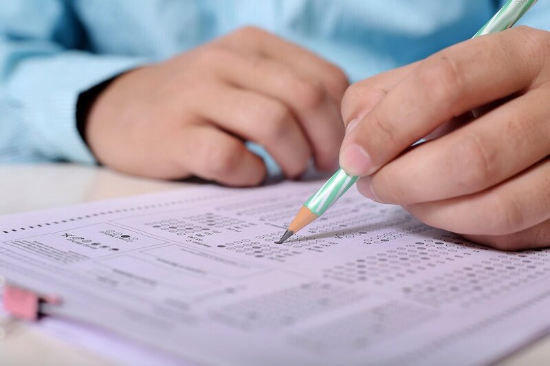 A student completing a test on purple paper
