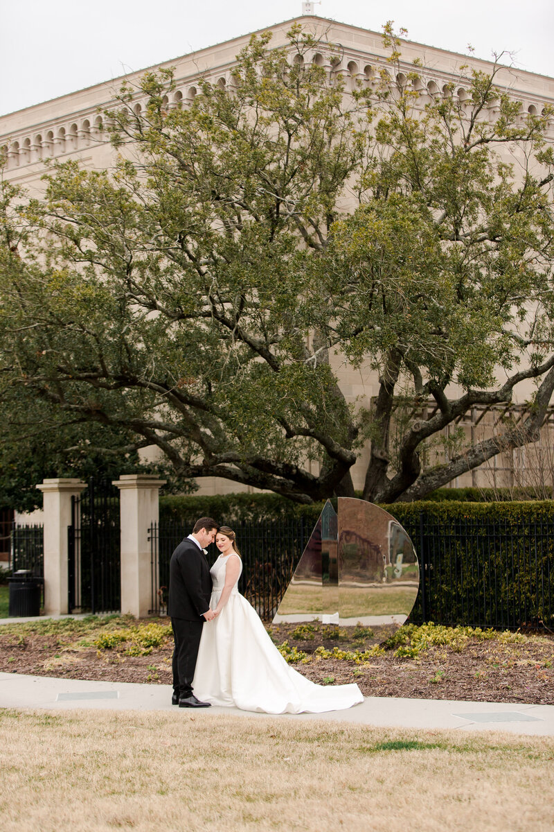 Wedding couple standing in front of tree at the Chrysler Museum of Art in Norfolk Virginia