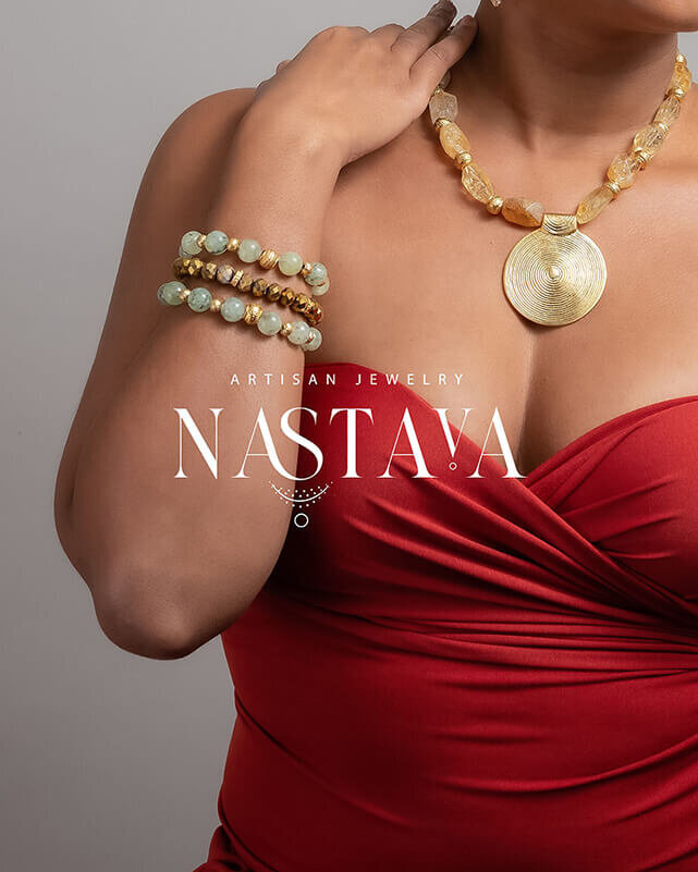 Black woman in a stunning strapless couture dress in a vibrant shade of red, adorned with eye-catching beaded bracelets and a striking statement necklace. The image also features an example of a custom logo for artisan jewelry, hinting at the exquisite craftsmanship and attention to detail in the accessories she wears.