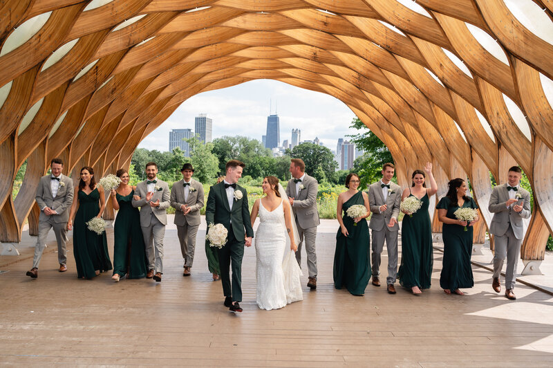 wedding party walks under the Honeycomb in Chicago