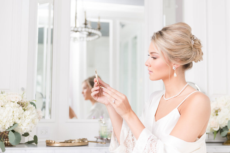 Beautiful bride looks at herself in the mirror