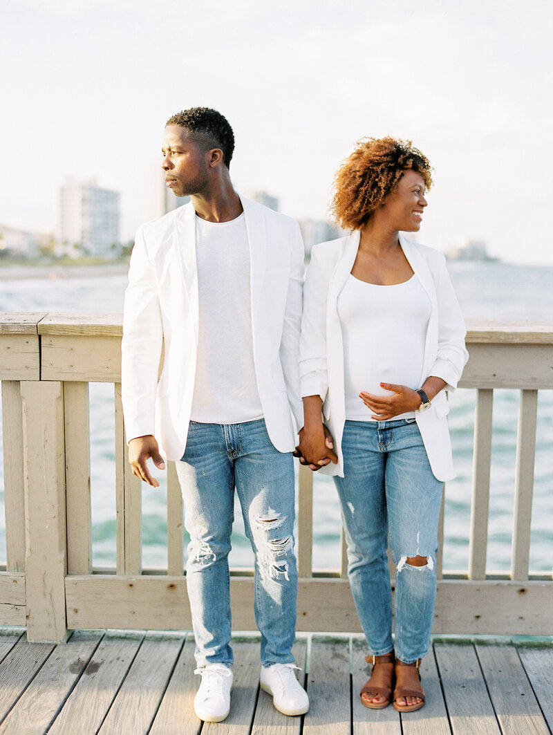 modern maternity session on the pier