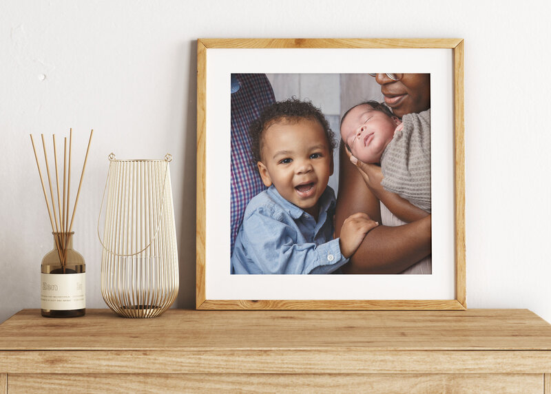 Framed portrait of a young family with two year old boy and newborn baby taken by Life in Pink Photography