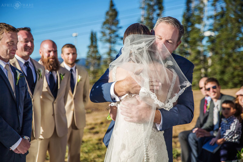 Bride hugs her dad at Four Points Lodge