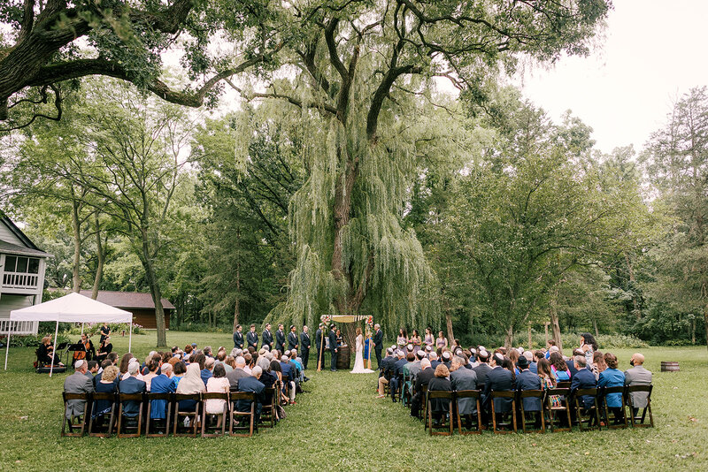 outdoor wedding ceremony under the willow tree at barnwood events in madison, winconsin,