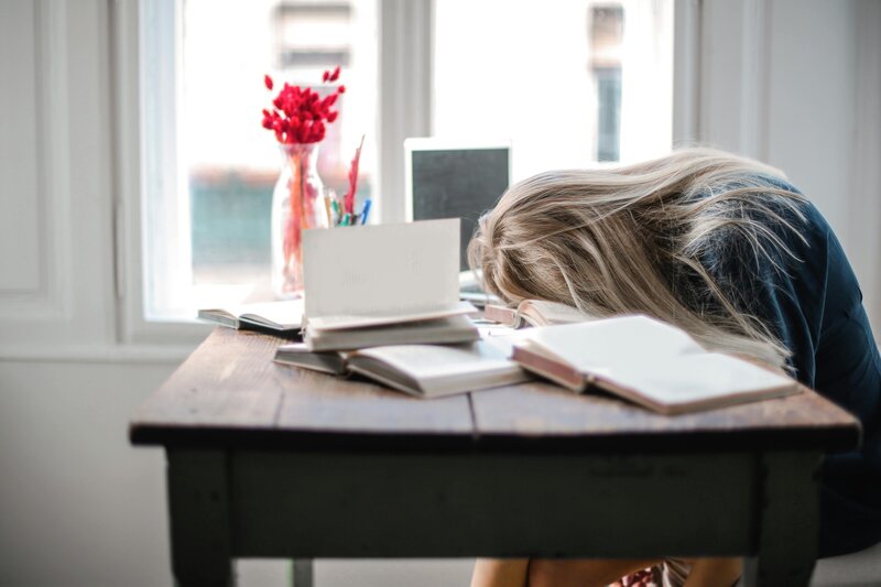 Student slouched over her homework at her desk