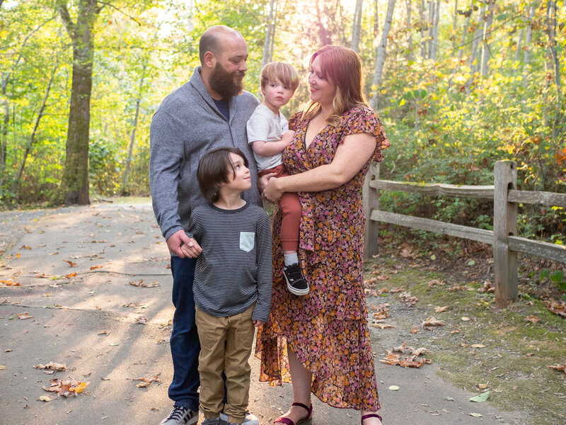 A family of four is embracing each other in a candid image by Seattle Family Photographer, Becky Langseth