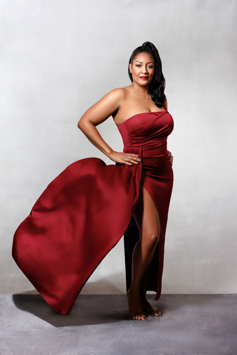 Black woman in red flowing gown.