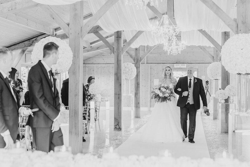 Bride-walking-down-aisle-at-Merrydale-Manor-Cheshire