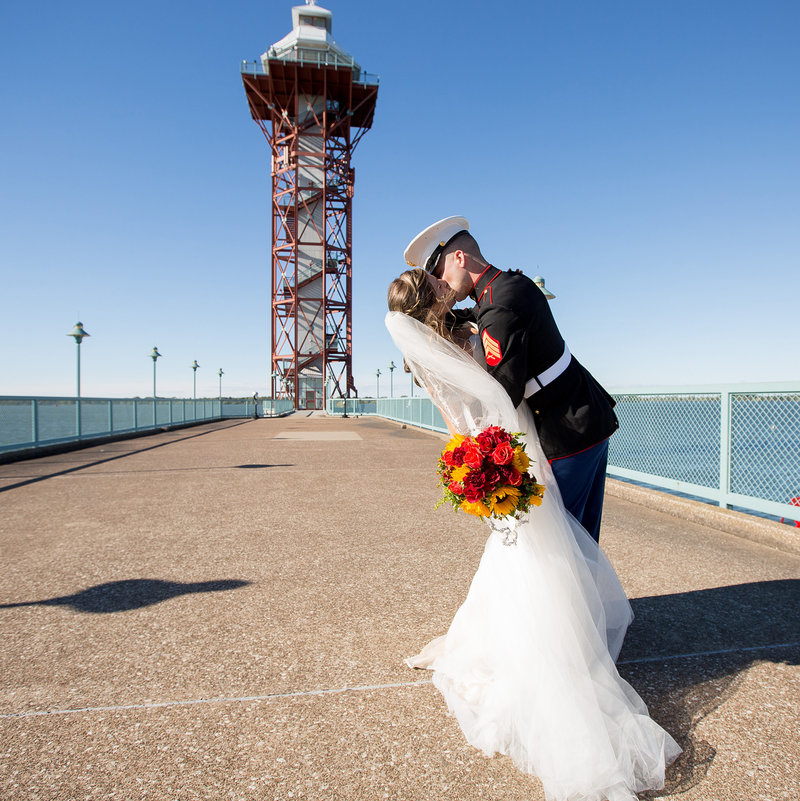 Bride and groom kiss in front of the Bicentennial Tower on Dobbin's Landing in Downtown Erie, PA