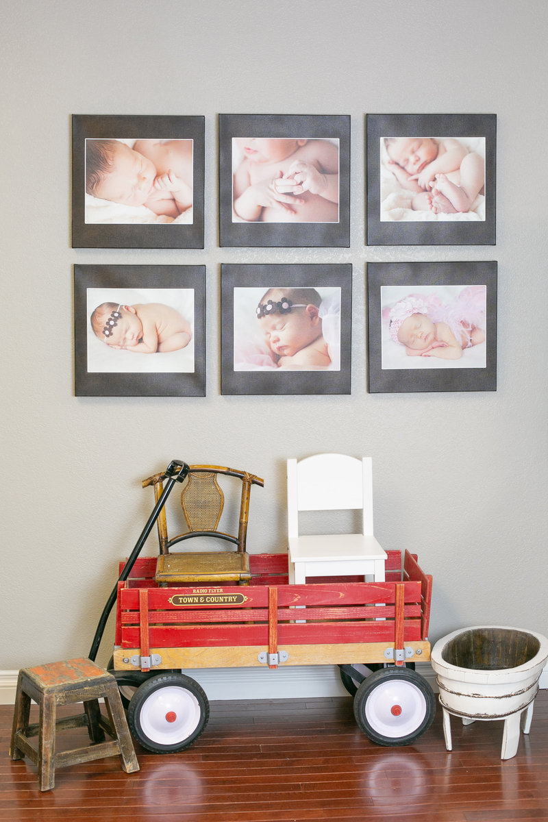 Photos of Denver babies hanging on the wall above red wagon