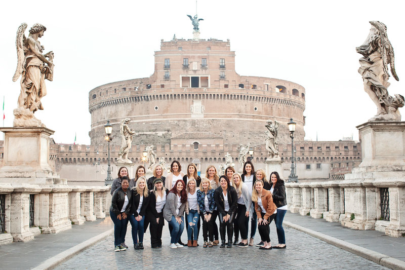 Photo of a large group girls trip in front of Castel Sant'Angelo. Taken by Rome Photographer, Tricia Anne Photography