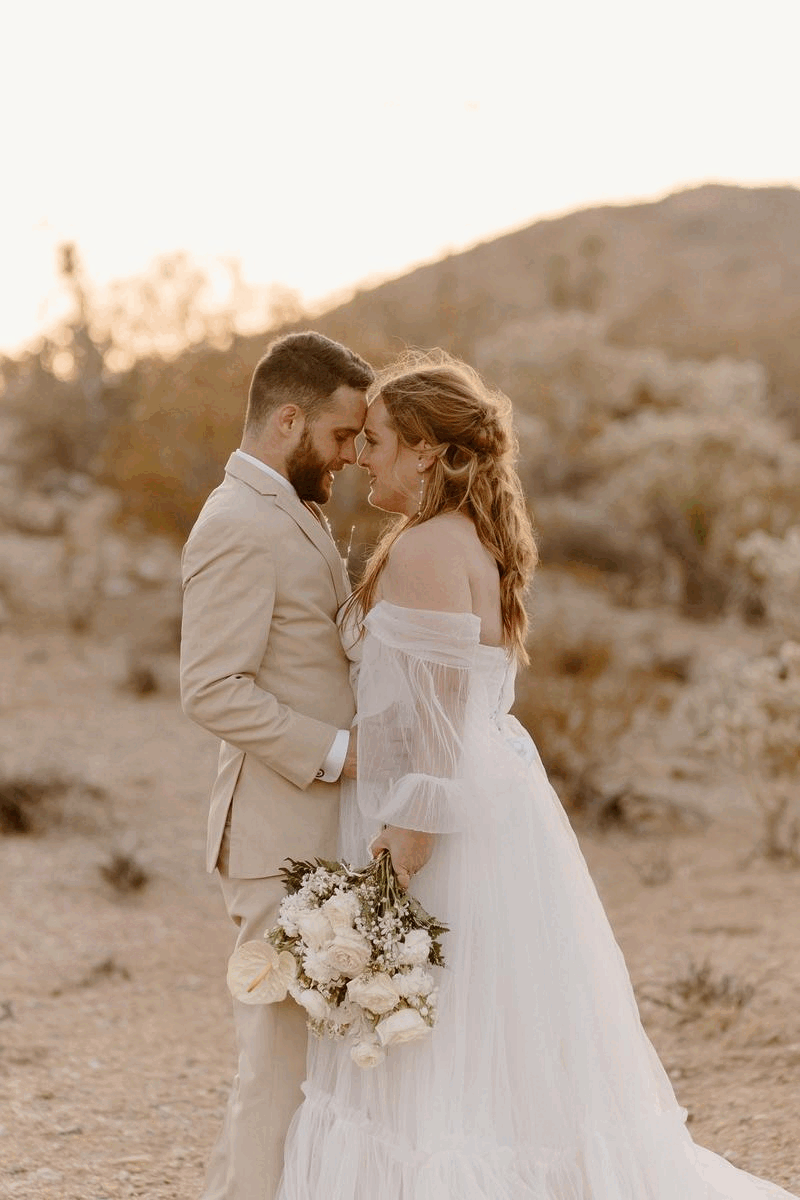 Bride and groom dancing in desert
