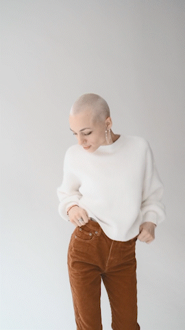 gif of a white woman with a shaved head dancing