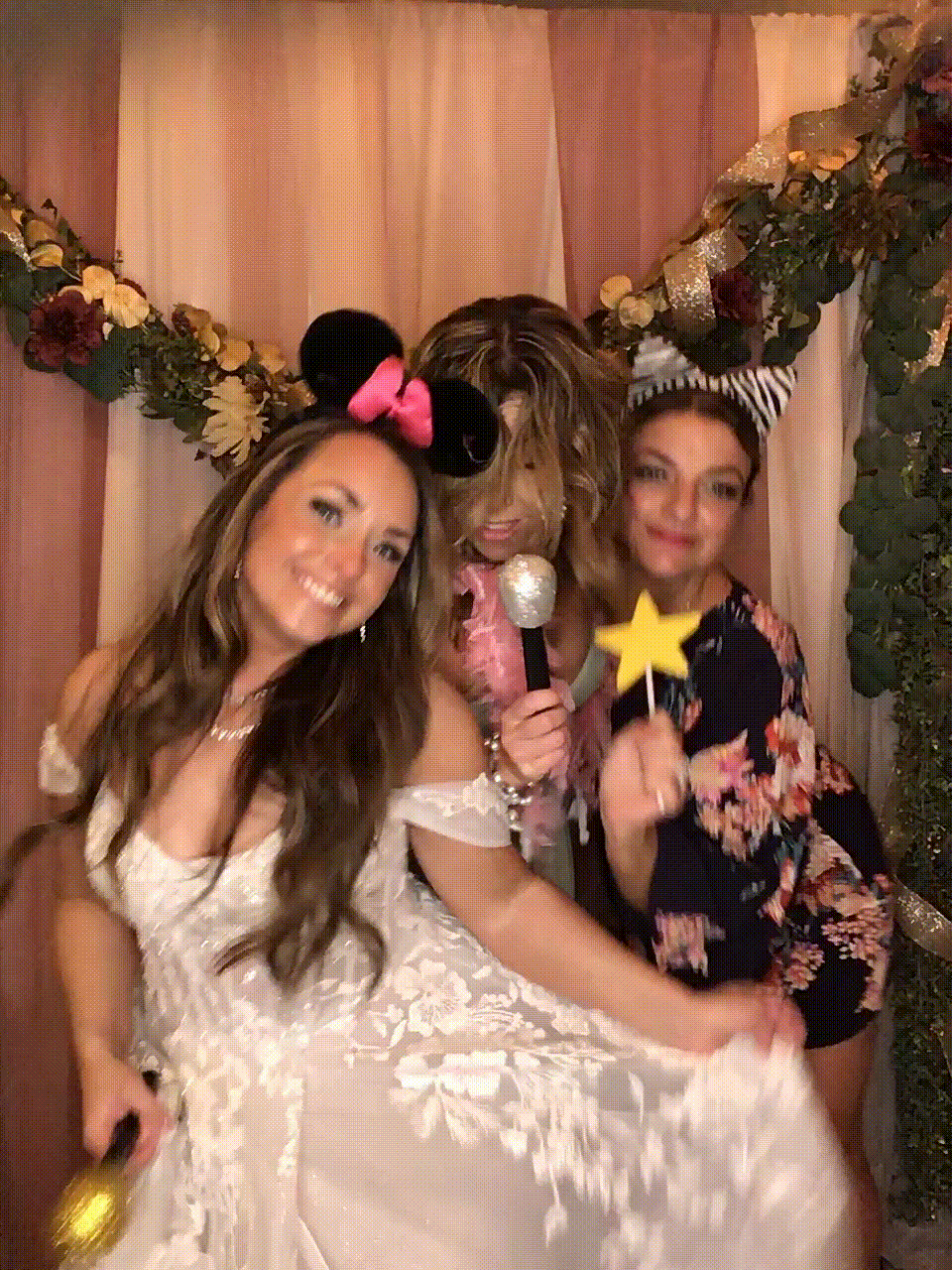 Bride dancing with friends in photo booth GIF