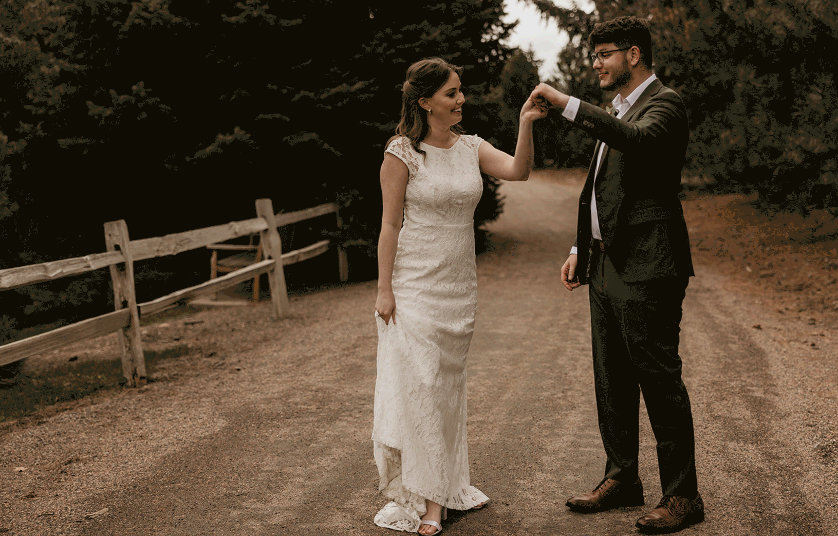 Groom twirls bride during intimate wedding at denvers hudson gardens.