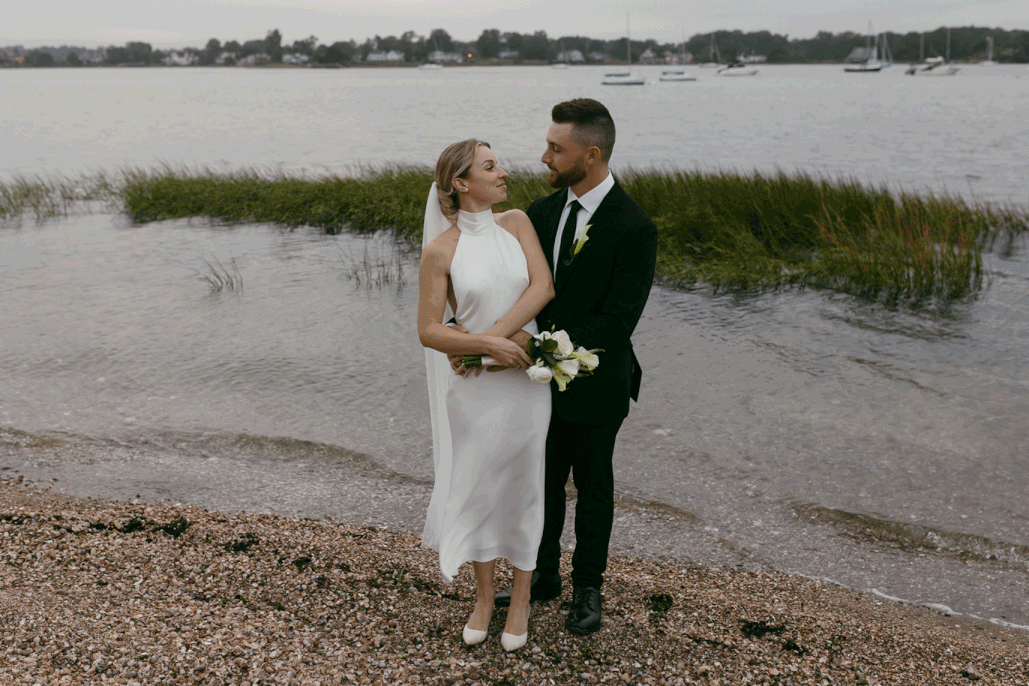photo of bride and groom kissing in front of marshy water taken by NYC elopement photographer