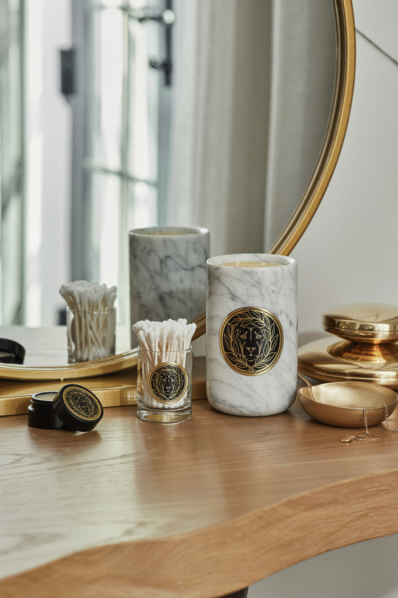 Hand lighting a Marble Leone Collection Candle