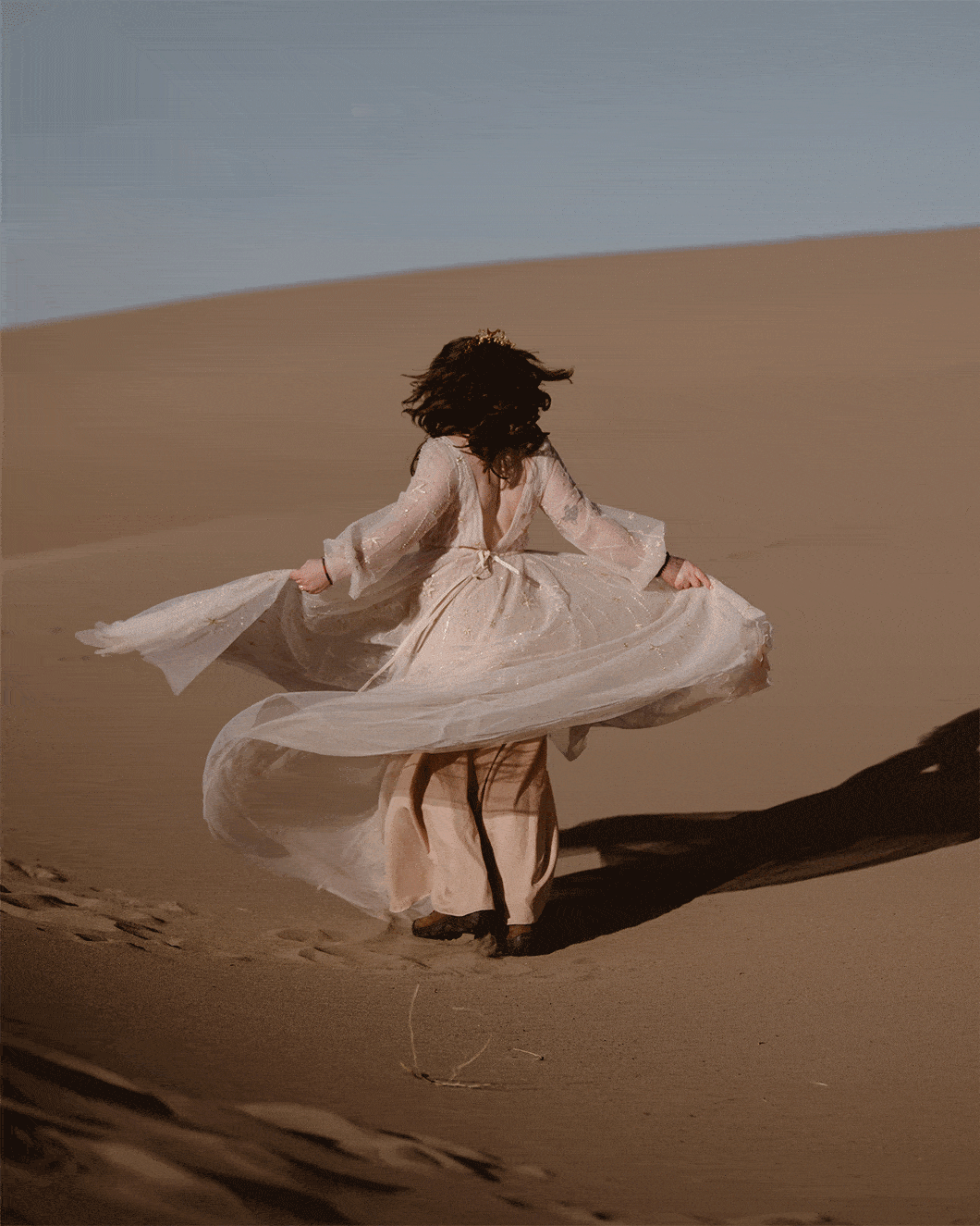 Bride spinning on the sand dunes during her elopement at Great Sand Dunes