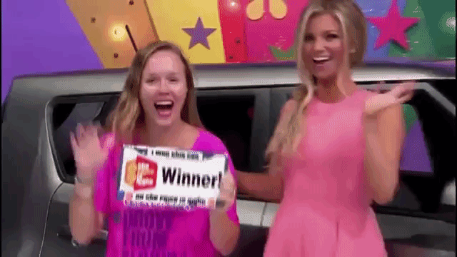 gif of emmiclaire photography waving with a winner sign in her hand on the price is right